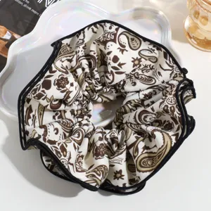Large floral print hair scrunchie with elegant black edge trim for daily hairstyles.