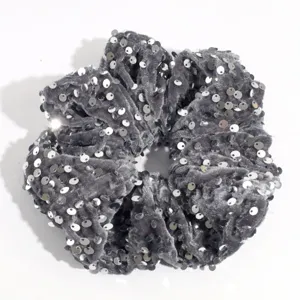 Grey velvet hair scrunchie detail view with sparkling silver sequins for elegant styling.