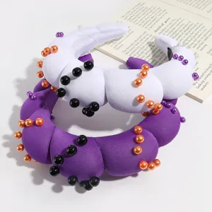 Detailed view of trendy padded sponge headbands with colorful pearls, perfect for party wear.