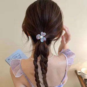 Detailed view of the elegant floral hair tie with pearl accent, perfect for daily hairstyles.