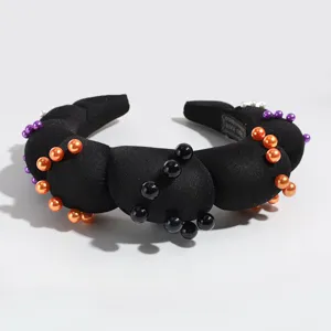 Black padded sponge headband decorated with colorful pearl beads for festive party styling.