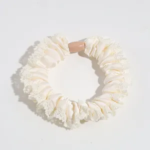 Details of the elegant satin scrunchie with delicate lace trim for daily commuting use.