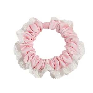 Pink satin scrunchie with white lace trim, elegant hair tie for women and girls daily wear.