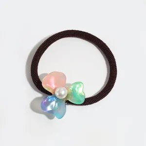 Minimalist faux pearl acetate flower hair rope, close-up view of cute ponytail rubber band.
