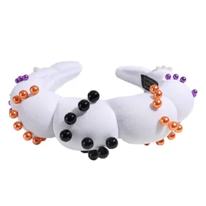 White padded cloud sponge headband decorated with black orange purple pearls for party.
