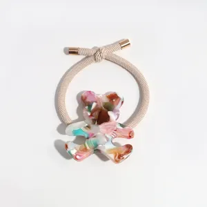 Cute colorful marble acrylic bear hair tie with beige elastic band and metallic tips.