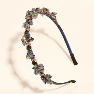 Vista dettagliata di un cerchietto con strass di cristallo blu scuro, accessorio.