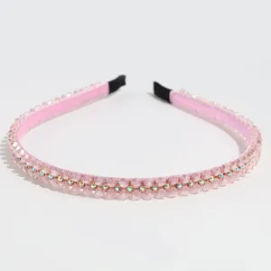 Pink crystal rhinestone headband detail close-up showing sparkly beaded hair accessory.