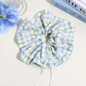 Blue yellow plaid hair scrunchie with cute white lace trim and bow ribbon detail for women.