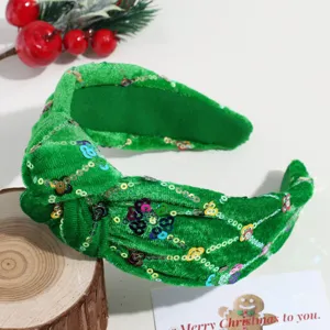 Groene fluwelen haarband met kleurrijke pailletten, perfect voor de kerstfeestjes.