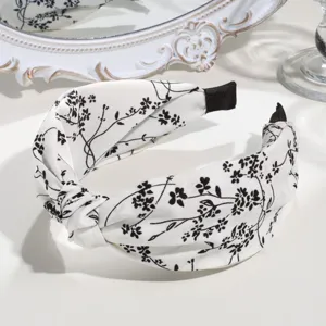 Black and white floral twist headband, elegant wide fabric hair hoop for daily fashion.