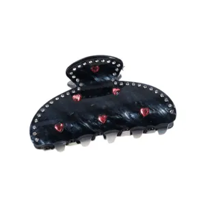 Elegante pinza para el pelo negra con pedrería y corazones rojos para peinados elegantes.