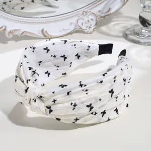 Detailed shot of the black and white floral knotted hair hoop, showcasing fabric texture.