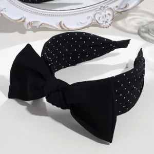 Black white polka dot bow headband detail, wide knot hair hoop showcasing exquisite fabric design.