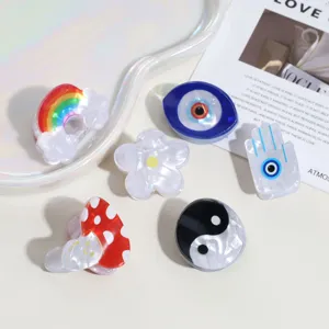 Cute mini acrylic hair claws set featuring rainbow, evil eye, flower, and yin yang designs.