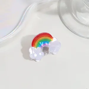 Close-up detail of a cute mini rainbow and cloud hair claw clip for daily hairstyles.