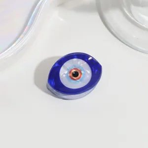 Detailed shot of the blue evil eye hair claw clip showing glossy resin texture and finish.