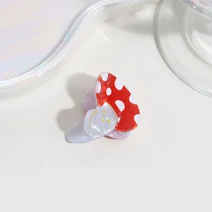 Cute mini mushroom hair claw clip detail close up, red white polka dot cute acrylic hair accessory.