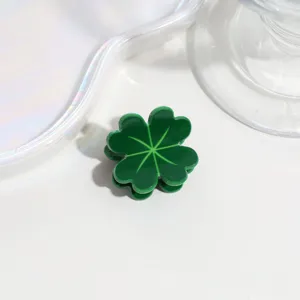 Mini green four-leaf clover hair claw clip, cute resin hair accessory for styling bangs.