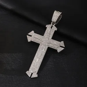 Close-up detail of a stunning iced out cross pendant with sparkling rhinestones, hip-hop style.