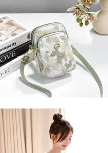 Detail view of the stylish Chinese style floral print double zipper mobile phone shoulder bag.