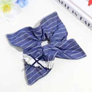 Blue striped hair scrunchie with white lace ruffle and bow detail, cute sweet hair accessory.
