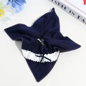 Dark blue hair scrunchie with white ruffle lace and cute bow design for sweet hair styling.