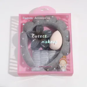 Detailed view of the wash headband, flower hair claw, makeup sponge and wristband gift set.
