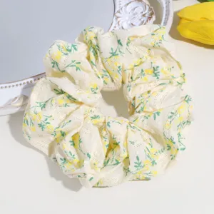 Detailed view of a sweet yellow floral lace scrunchie, perfect for cute daily hair styling.