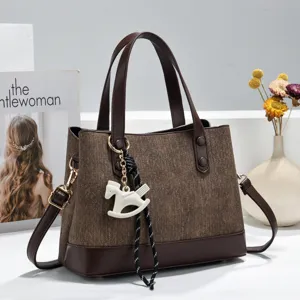 Brown patchwork tote handbag with shoulder strap and cute rocking horse charm for women.