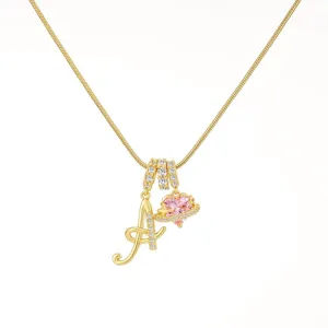 Exquisite gold snake chain necklace featuring letter A and sparkling pink heart Saturn pendant.