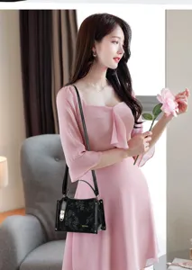 Elegant black embossed floral women handbag with lock and strap for daily commute.