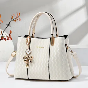 Elegant cream white wavy texture handbag with bow charm, stylish shoulder bag for women.