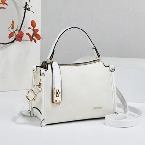 White mini top handle crossbody shoulder bag with metal lock clasp and subtle debossed floral design.