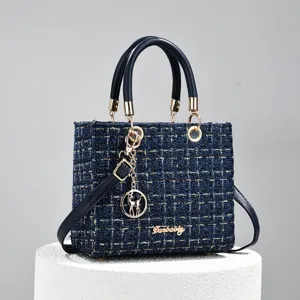Blue tweed top handle handbag for women, classic structured crossbody shoulder bag with charms.