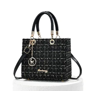 Black tweed top handle shoulder bag for women, classic structured design with chic metal hardware.