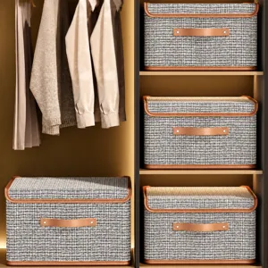Opvouwbare tweed stoffen opbergdoos met deksel en lederen handvat voor kledingkast.