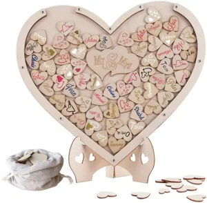 Wooden heart wedding guest book drop box with stand and personalized tokens for parties.