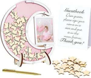 Close-up details of wooden moon guestbook frame with star tokens, sign card and golden pen.