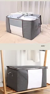 Large gray quilted quilt storage bag with clear window and handles for bedding clothes.