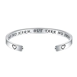 Stainless steel cuff bracelet detail, silver metal engraved inspirational jewelry design.