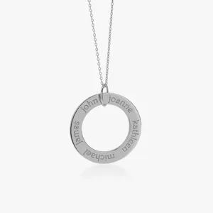 Close-up detail of custom engraved circle pendant necklace featuring elegant metallic silver finish.