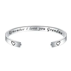Stainless steel cuff bracelet detail showing engraved family love quote and cute heart ends.
