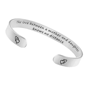 Stainless steel mother daughter cuff bracelet with engraved love quote and heart ends detail.