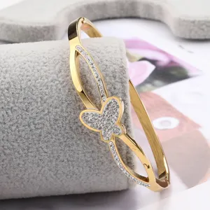 Stainless steel gold tone rhinestone butterfly bangle detail view, elegant interlocking design bracelet.