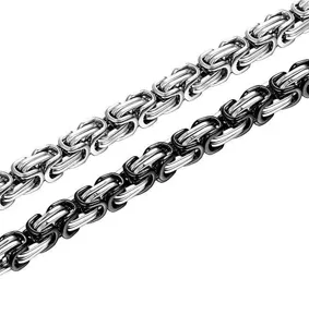 Close-up view of thick stainless steel Byzantine king chain bracelet detail and texture.