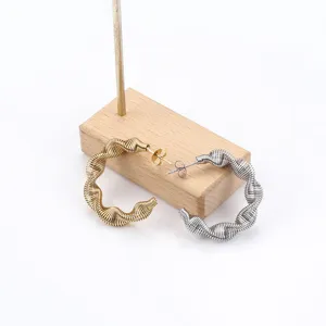 Trendy stainless steel spring hoop earrings, unique twist design for modern women.