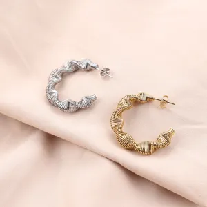 Twisted spring stainless steel hoop earrings in silver and gold, trendy minimalist jewelry.