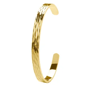 Close-up of a stylish gold-plated hammered cuff bracelet featuring a unique textured design.