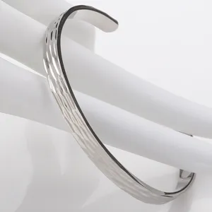 Detail shot of a stylish silver-tone stainless steel hammered open cuff bracelet.